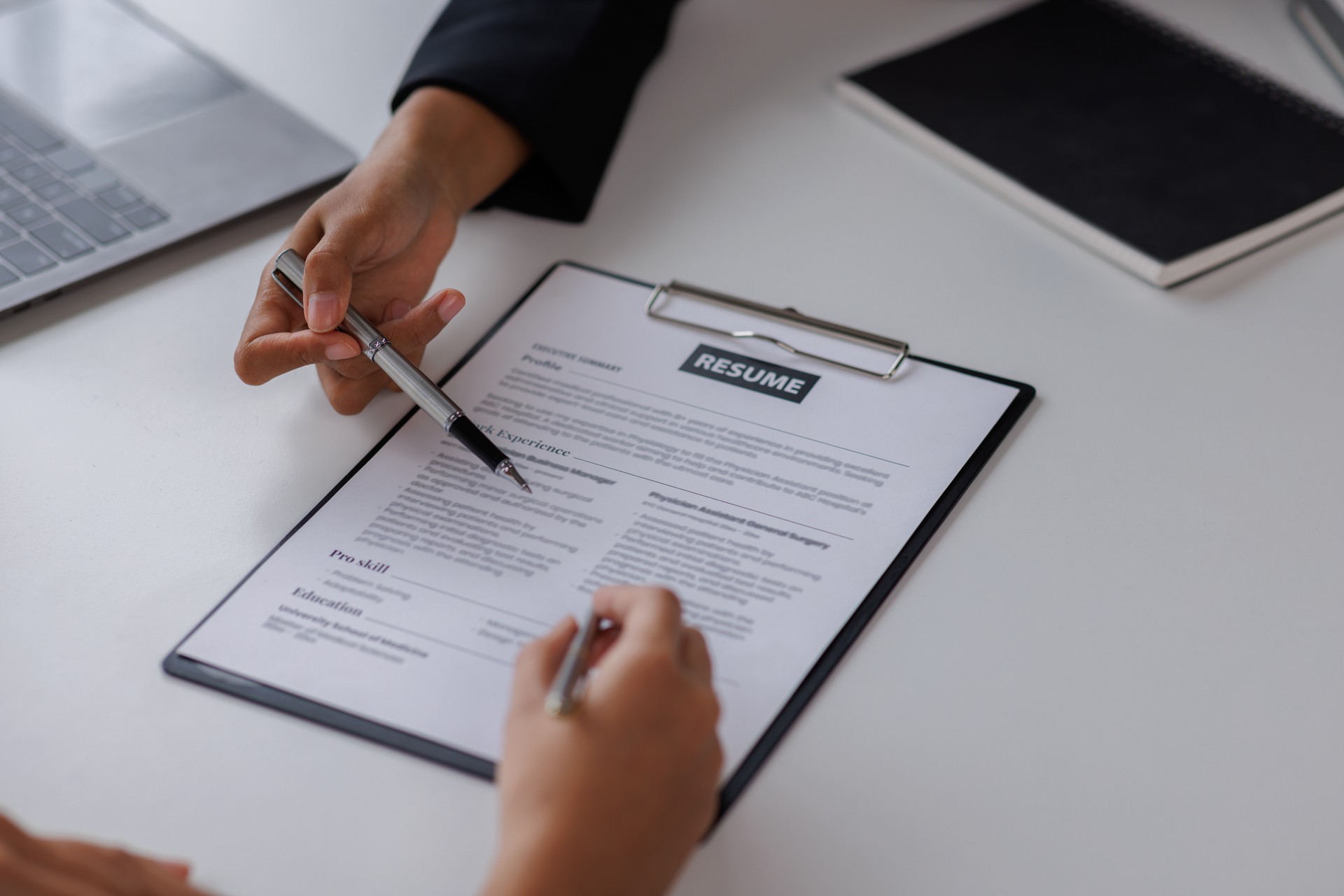 Examiner reading a resume during job interview at office Business and human resources concept.